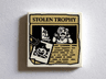 Tile 2 x 2 with Paper Clip, Pumpkin Jack O' Lantern Image and 'STOLEN TROPHY' Newspaper Article Pattern
