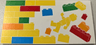 Tile 8 x 16 with Bottom Tubes, Textured Surface with Yellow, Orange, Dark Azure, Red and Bright Green Bricks, Brick Wall and Minifigure Pattern Model Left Side