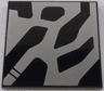 Tile 4 x 4 with Silver Markings Pattern Model Left Side (SW Kylo Ren Helmet)
