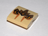 Slope, Curved 2 x 2 x 2/3 with Lion Armor and Eyes Pattern