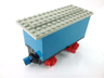 Train Battery Box Car with Two Contact Holes, Red Switch Lever, Blue and Red Magnets, Red Wheels, and Light Gray Roof