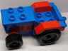 Duplo Farm Tractor with Black Wheels, Red Engine and Fenders, and Blue Hitch